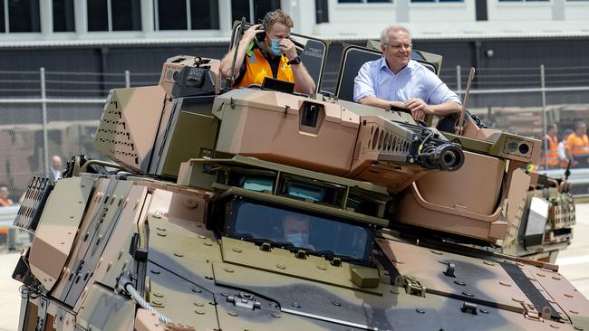 Scott Morrison, right, rides in a new Australian Boxer CRV at the official opening of the Rheinmetall Military Vehicle Centre of Excellence in Redbank, Queensland, on Sunday. Picture: Sarah Marshall