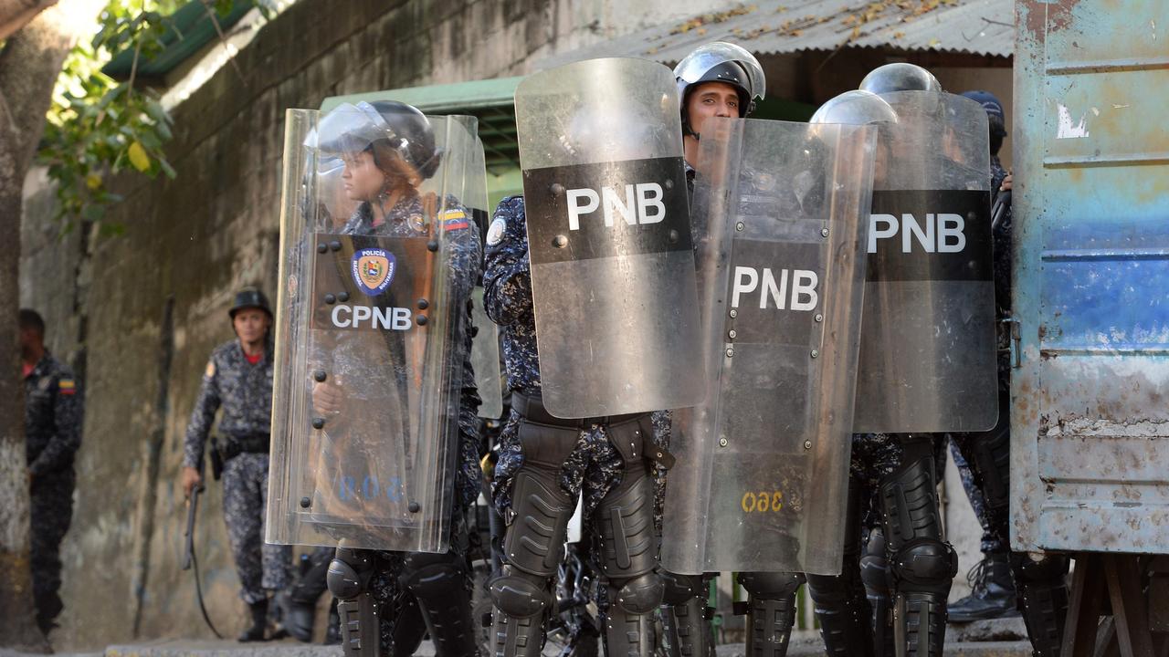Riot police clash with anti-government demonstrators in the neighbourhood of Los Mecedores, in Caracas.