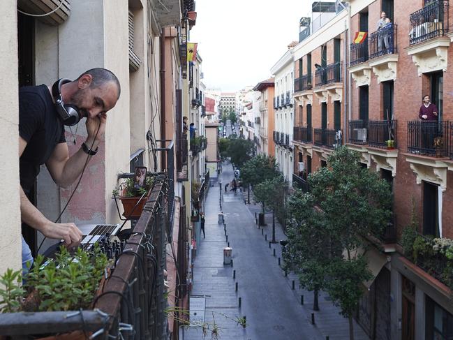 DJ ChechuIbiza performs at the balcony of his home for the people staying inside as a precaution against the coronavirus in Madrid. Picture: Getty Images