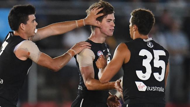 Matthew Kennedy and Ed Curnow (right) rush to congratulate Paddy Dow after his first goal. Pic: AAP