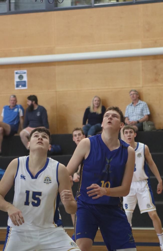 Boom Churchie recruit Harrison Pennisi battling for a rebound against Nudgee College in round one of the GPS Basketball competition.