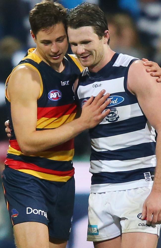 Patrick Dangerfield of the Cats catching up with former team-mate Jake Lever of the Crows.