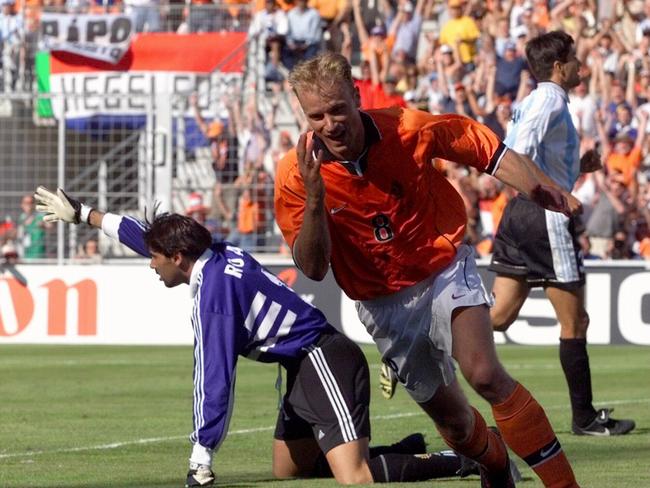 Dennis Bergkamp celebrates in jubilant fashion after scoring the winner.