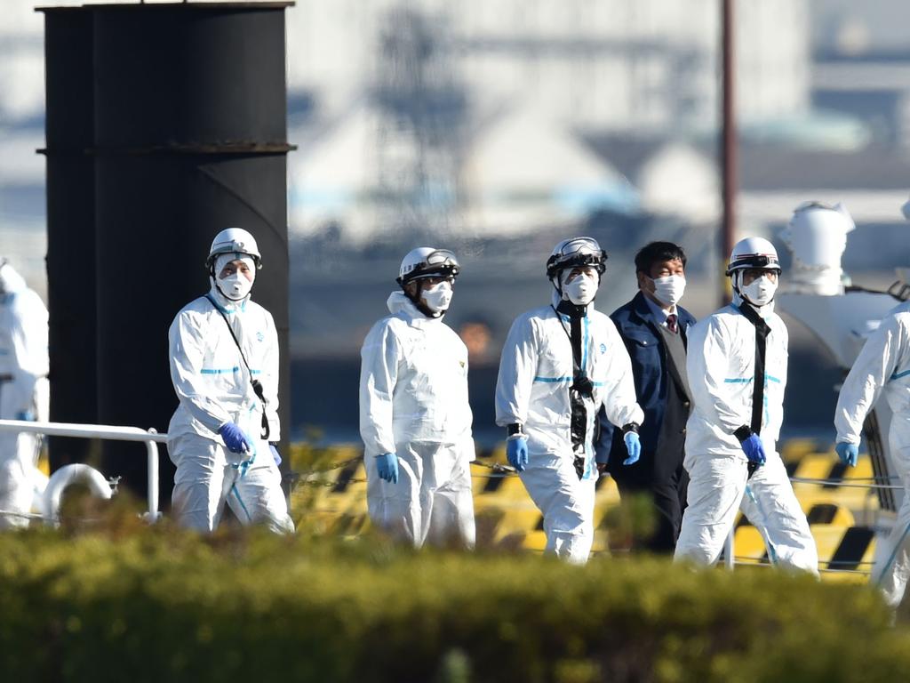 Personnel clad in protective gear, tasked to provide care for suspected patients on board the Diamond Princess cruise ship, are seen at the Japan Coast Guard base in Yokohama. Picture: Kazuhiro Nogi/AFP.