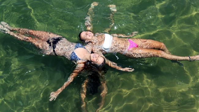 Charlee Evers, 16, and Daley Hodgson, 16, with Zara Halliday, 15, at Manley Cove. Picture: Tim Hunter