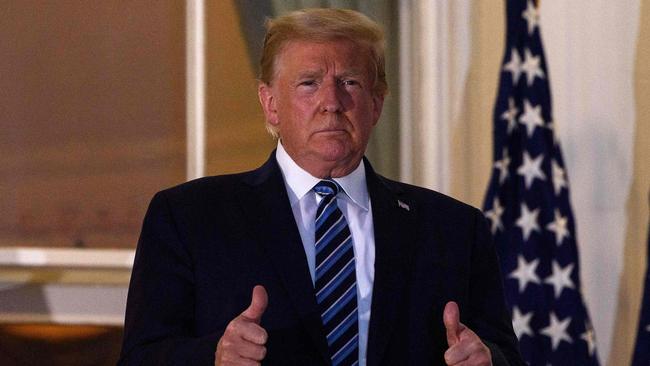 US President Donald Trump gives two thumbs up from the Truman Balcony upon his return to the White House. Picture: Nicholas Kamm/AFP