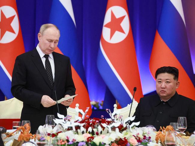 Russian President Vladimir Putin speaks as North Korean leader Kim Jong-un listens during a reception at the Mongnangwan Reception House in Pyongyang in June. Picture: Sputnik