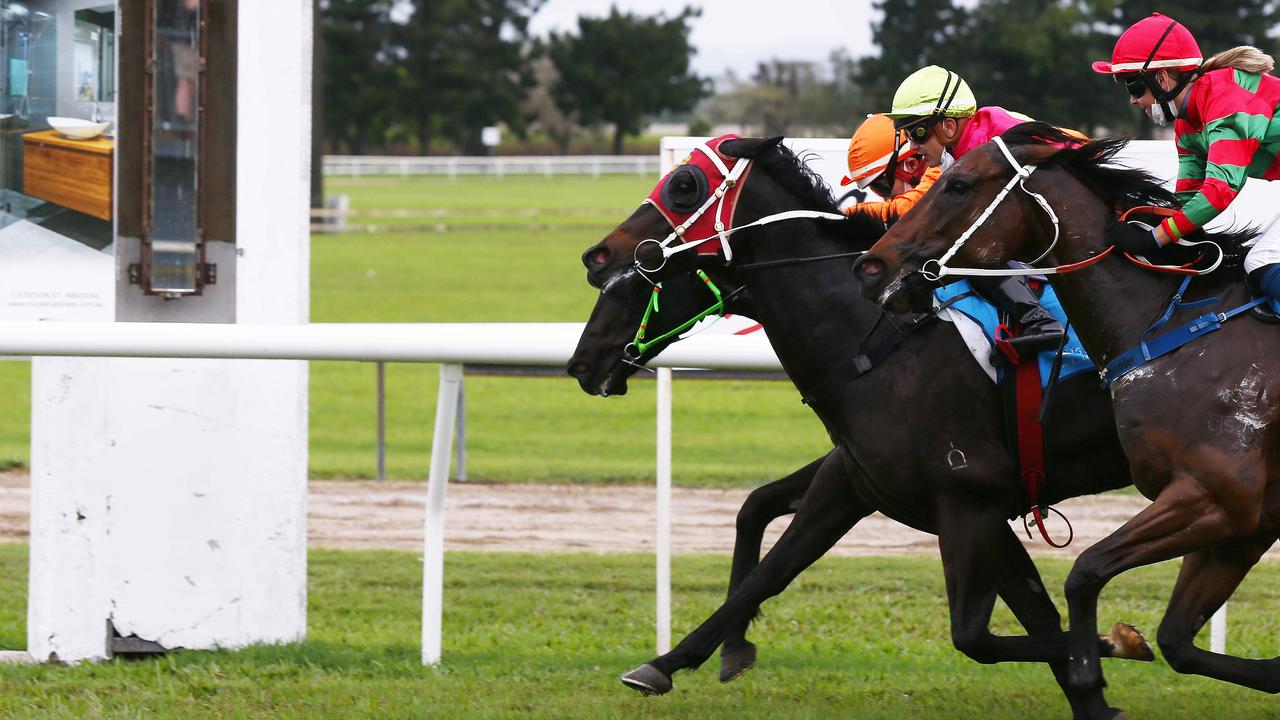 War General, ridden by Masayuki Abe (orange silks), narrowly edges out Sylvester and Cadence to win Race 3, the 900 metre Benchmark 60 Handicap at the Banana Industry Race Day, held at the Innisfail Turf Club. Picture: Brendan Radke