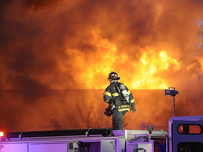 Job security more important than romance ... A firefighter assesses the scene of a large blaze.