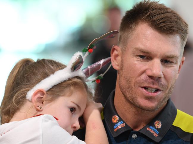 David Warner with his daughter Ivy Mae at Melbourne Airport