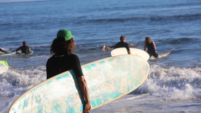 Members of the public took part in a paddle-out at Byron Bay's Main Beach to protest against the planned Netflix reality show Byron Baes on the morning of Tuesday, April 20, 2021. Picture: Liana Boss