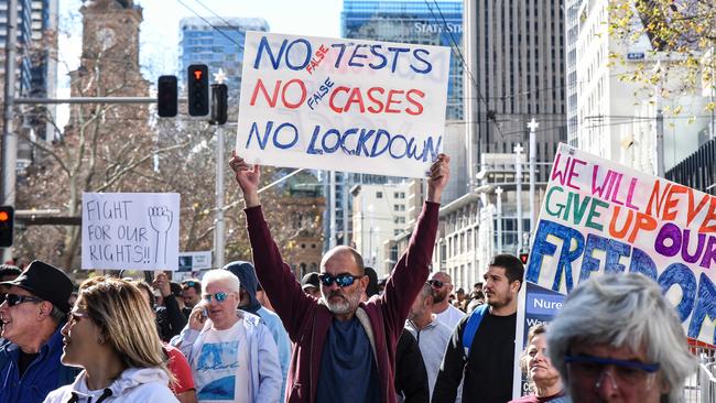 Protesters march down Sydney’s George St during an anti-lockdown protest on Saturday. Picture: Flavio Brancaleone