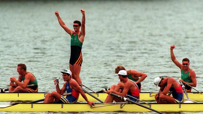 Nick Green standing up in the boat after the Oarsome Foursome won gold at the Atlanta Olympic Games.