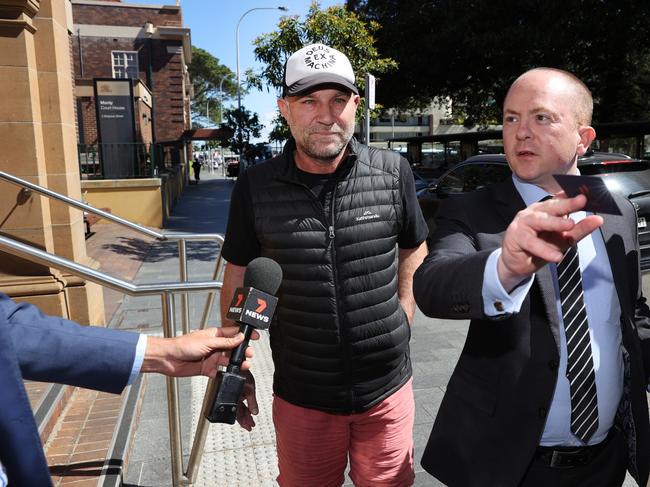 Michael Slater (left) leaving Manly Police Station, with his solicitor James McLoughlin, after being granted bail in October 2021 on domestic violence charges. Picture: Richard Dobson