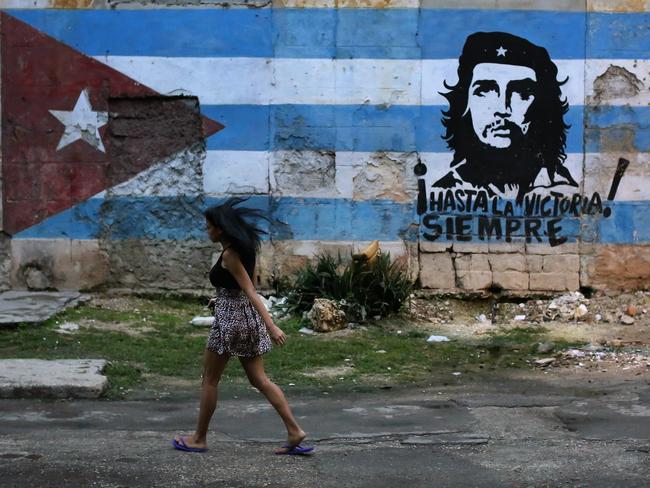 A woman walks past a Che Guevara mural in Havana, Cuba, which is the ultimate prize in Washington’s Latin America gamble. Picture: Getty Images 