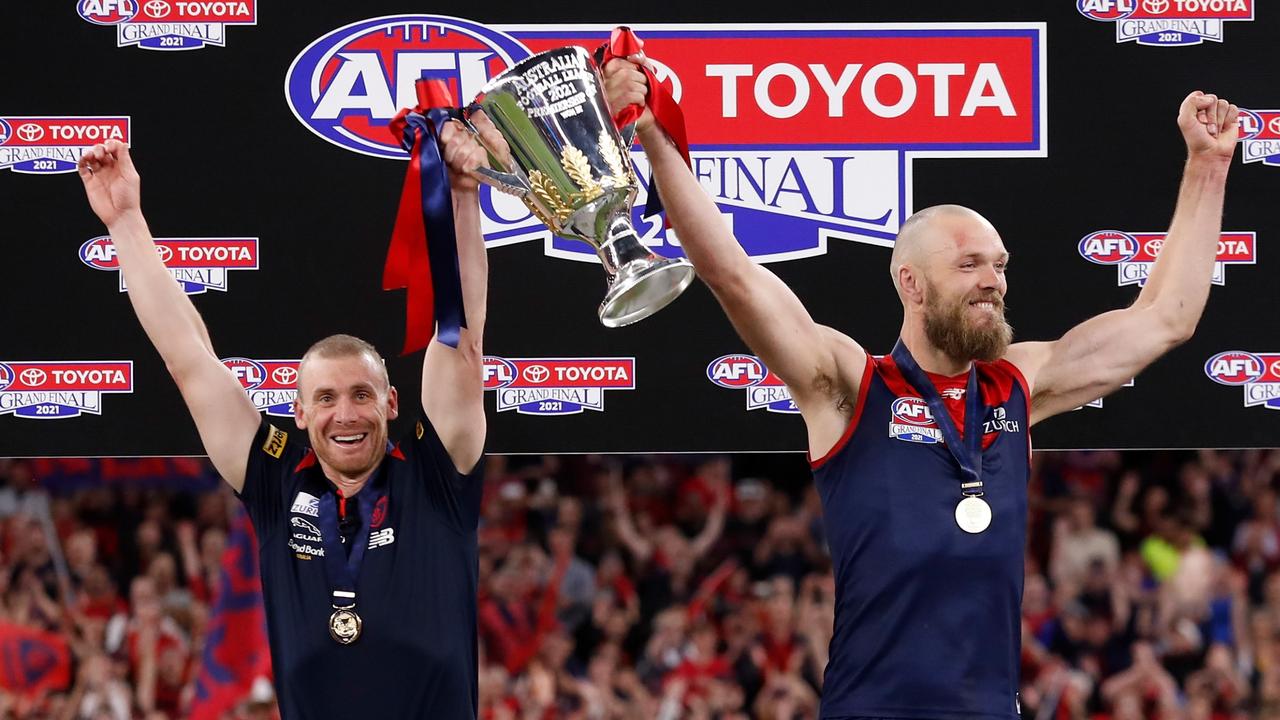 Simon Goodwin, Senior Coach, and Max Gawn of the Demons hold the cup aloft during the 2021 Toyota AFL Grand Final.