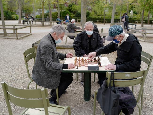 Masked men play chess in a Paris park. Picture: AFP