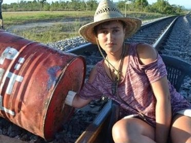 A protester chained to a drum on a rail line near Adani's Abbot Point coal terminal last year