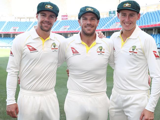 DUBAI, UNITED ARAB EMIRATES - OCTOBER 07:  Travis Head, Aaron Finch and Marnus Labuschagne of Australia pose after receiving their Baggy Green Caps during day one of the First Test match in the series between Australia and Pakistan at Dubai International Stadium on October 7, 2018 in Dubai, United Arab Emirates.  (Photo by Ryan Pierse/Getty Images)