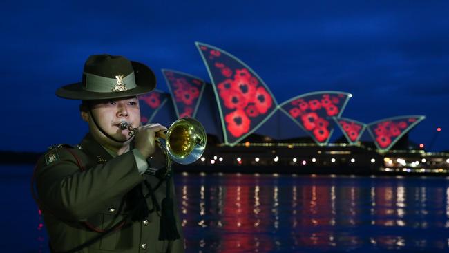 SYDNEY, AUSTRALIA : NewsWire Photos - NOVEMBER 11 2024; The Minister for Veterans, David Harris, joins the RSL NSW President, Mick Bainbridge, for a Remembrance Daydawn service with poppies projected on the shells of the Sydney Opera House. Picture: NewsWire / Gaye Gerard