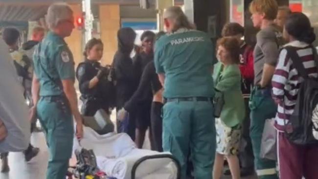 Dr Robyn Lawrence, in green, with paramedics after providing first aid to a woman stabbed in the CBD. Picture: 9 News