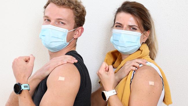 Liam Howell 26 and Caroline Giardina 29 after getting the Covid-19 vaccine shot, their first shots of Pfizer. Tom Tate is urging Gold Coasters to roll up their sleeves. Picture: Toby Zerna