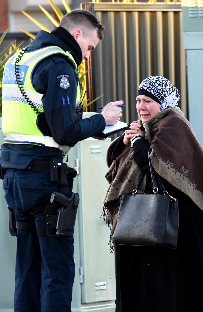 Police speak with a woman. Picture: Nicole Garmston