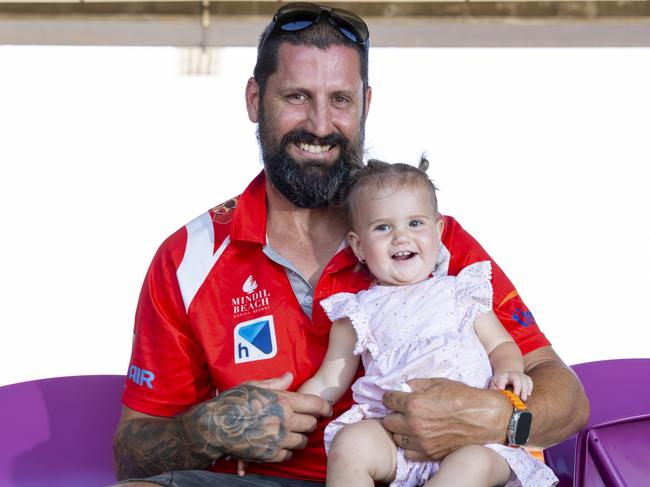 Father and daughter Chris and Luella Bryan enjoying the NTFL prelim finals on Saturday afternoon. Picture: Floss Adams.