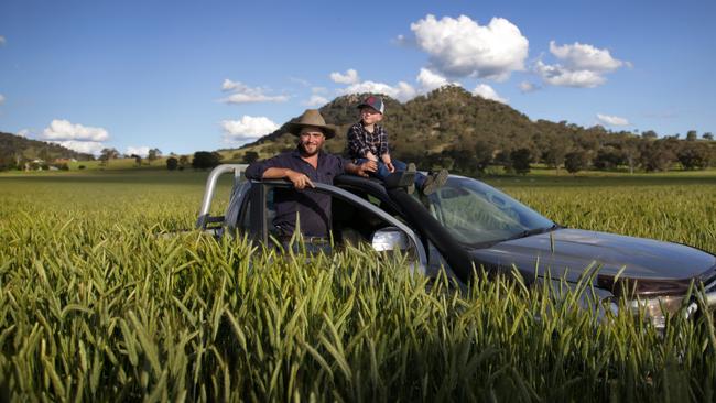 Jono Clarke, with his son Angus, 7, says his crop is just too wet to harvest. Picture: Dean Marzolla