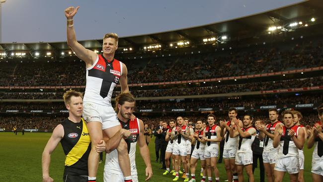 Nick Riewoldt gets chaired off by Josh Bruce and Jack Riewoldt after playing his final game at the MCG. Pic: Michael Klein