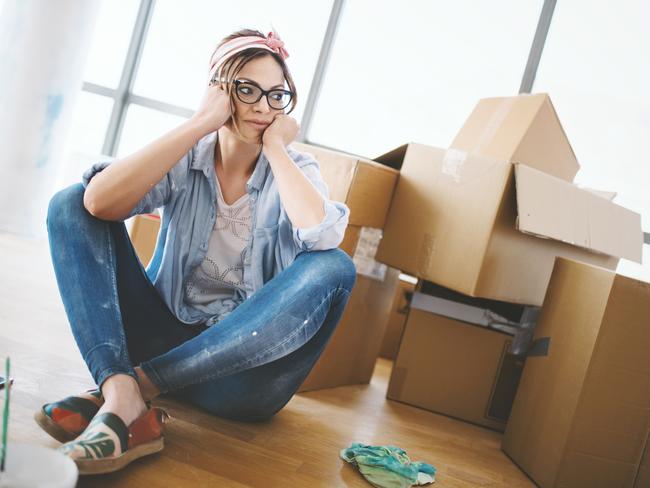 Young woman sitting on the floor, tired of all the work that she done by herself at her apartment. Eviction. Tenant. Renter. Renting. Evicted. Source: iStock - for Herald Sun realestate