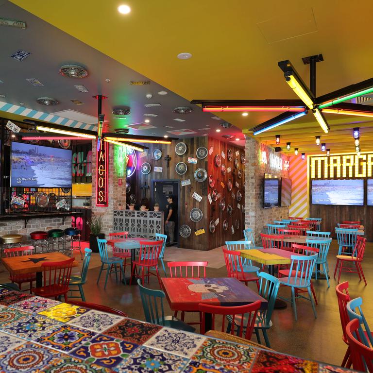 The fit-out which is flooded in neon signage and bright lights, colourful murals, and eccentric accessories such as cactuses, crosses, calavera, hubcaps and festoon lighting. Picture Glenn Hampson