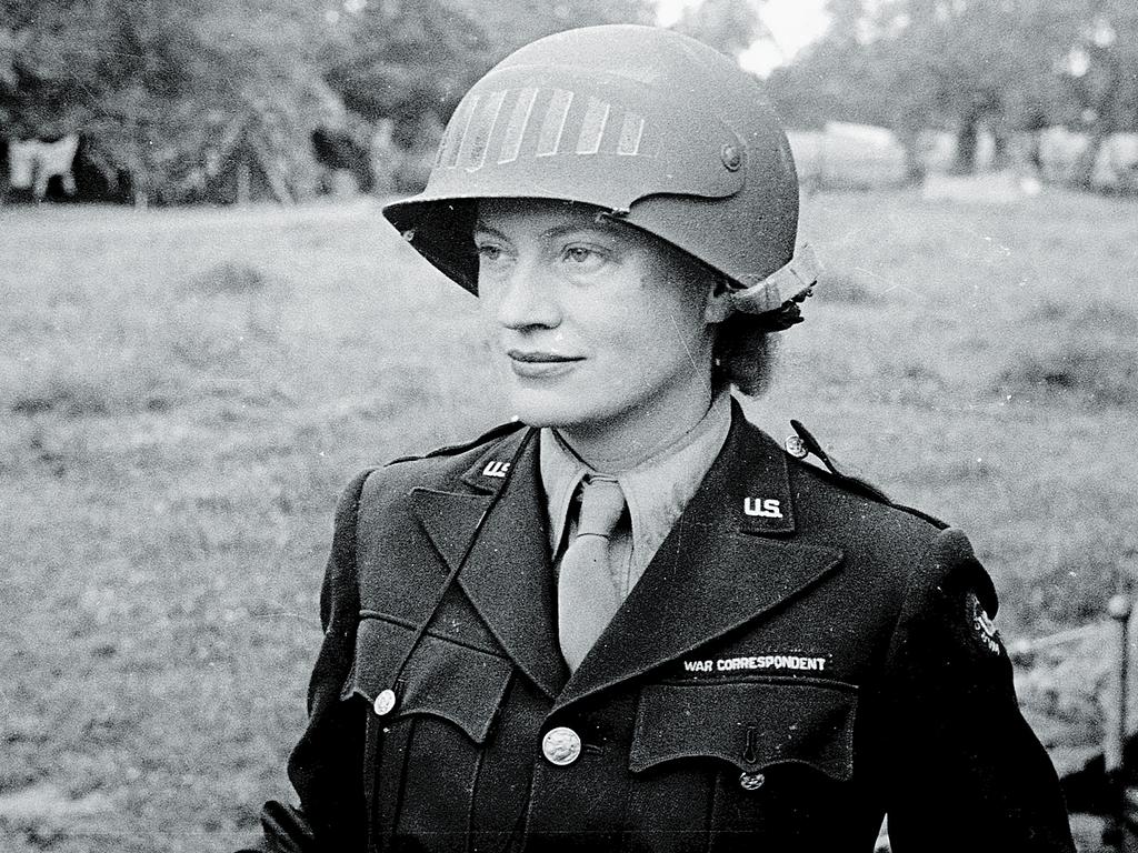 Lee Miller, in a steel helmet specially designed for using a camera, in Normandy, 1944.