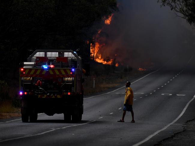 Rural Fire Service (RFS) firefighters prepare for property protection near the town of Sussex Inlet on December 31, 2019 in Sydney, Australia. There are a number of dangerous bushfires burning at emergency level across NSW as weather conditions deteriorate with temperatures expected to rise ahead of gusty southerly change. Princes Highway on the NSW South Coast has been closed with motorists told to avoid all non essential travel. Volunteer firefighter Sam McPaul was killed when his truck rolled over in a freak wind event near Jingellic near the NSW-Victorian border on Monday evening. Picture: Sam Mooy/Getty