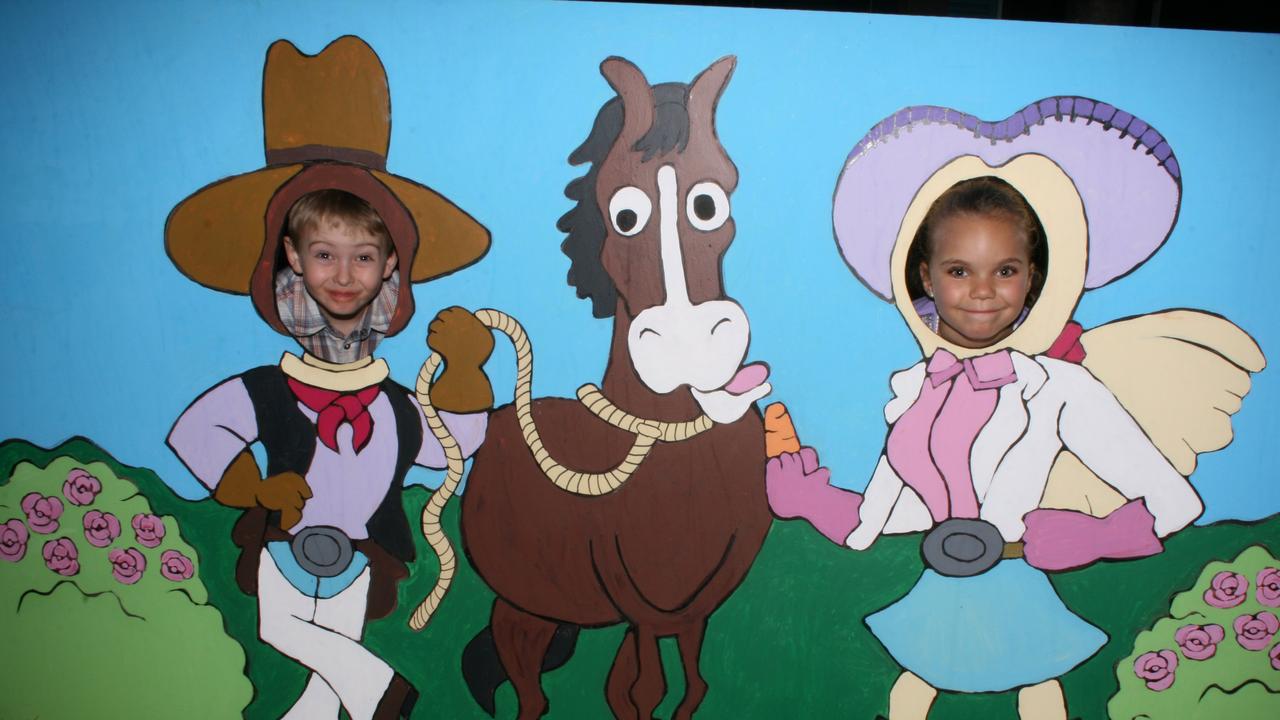 <p>Kurt Miller and Alyah Enosa have fun with the rodeo photo board at the Warwick Rodeo Mardi Gras. Photo Deanna Millard / Daily News</p>