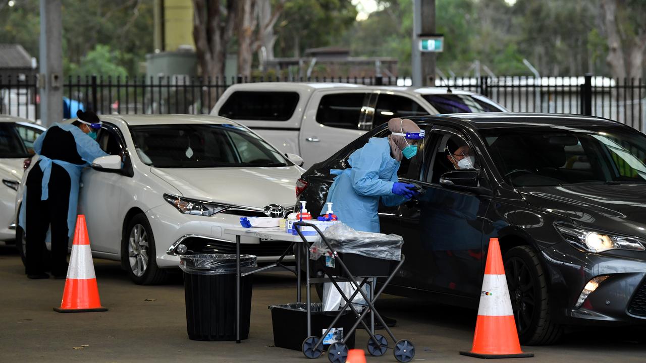 Health workers testing people at the Fairfield Showground Covid testing site, where long queues meant up to four hour waits. Picture: Joel Carrett/NCA NewsWire