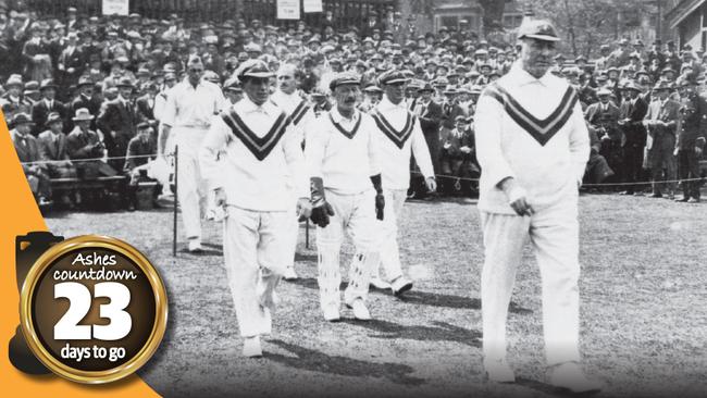 Warwick Armstrong (R) leads the Australian team on to the field.