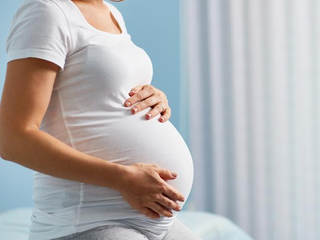 Pregnant woman sitting in childbearing center