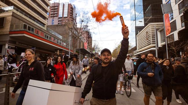 A man with a flare at the Melbourne Freedom Rally. Picture: Mark Stewart