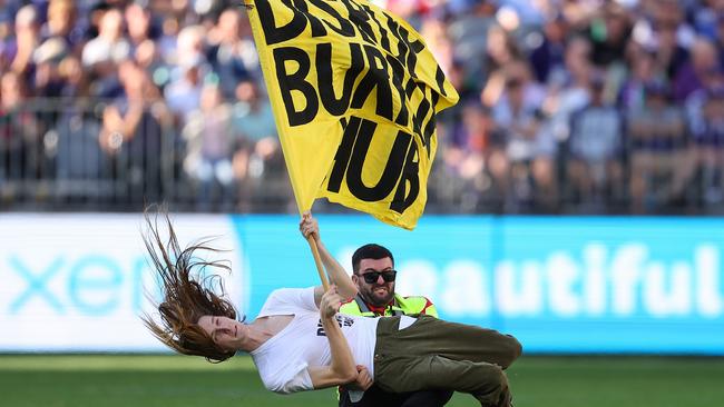 Pitch invader Emil Davey was tackled to the ground by a security guard. Picture: Paul Kane/Getty Images