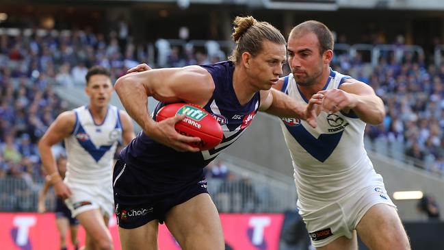 PERTH, AUSTRALIA - MAY 27: Nathan Fyfe of the Dockers fends off a tackle by Ben Cunnington of the Kangaroos during the round 10 AFL match between the Fremantle Dockers and the North Melbourne Kangaroos at Optus Stadium on May 27, 2018 in Perth, Australia.  (Photo by Paul Kane/Getty Images)