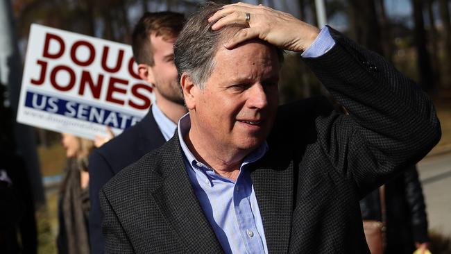 Democratic senatorial candidate Doug Jones prepares to greet voters outside of a polling station in Bessemer, Alabama.