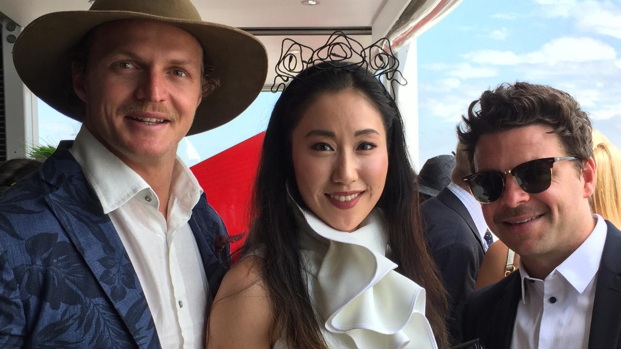 Welcome to Australia. We’re guessing “Jamie” Qianqian Wu (centre) probably hadn’t met Nick “Honey Badger” Cummins (left) before the Melbourne Cup.