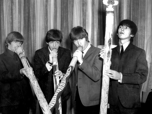 Beatles Australian tour 1964 (L-R) Ringo Starr, Paul McCartney, John Lennon and George Harrison playing didgeridoos - Picture: News Corp