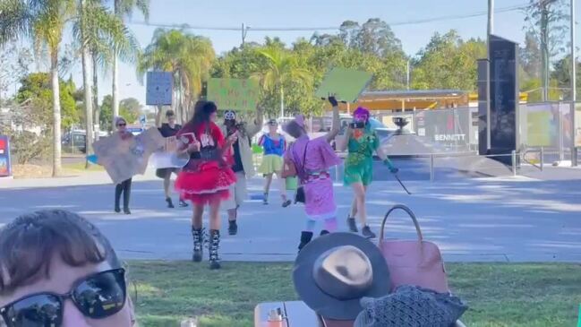 Costumed protesters crash Lismore flood recovery media event