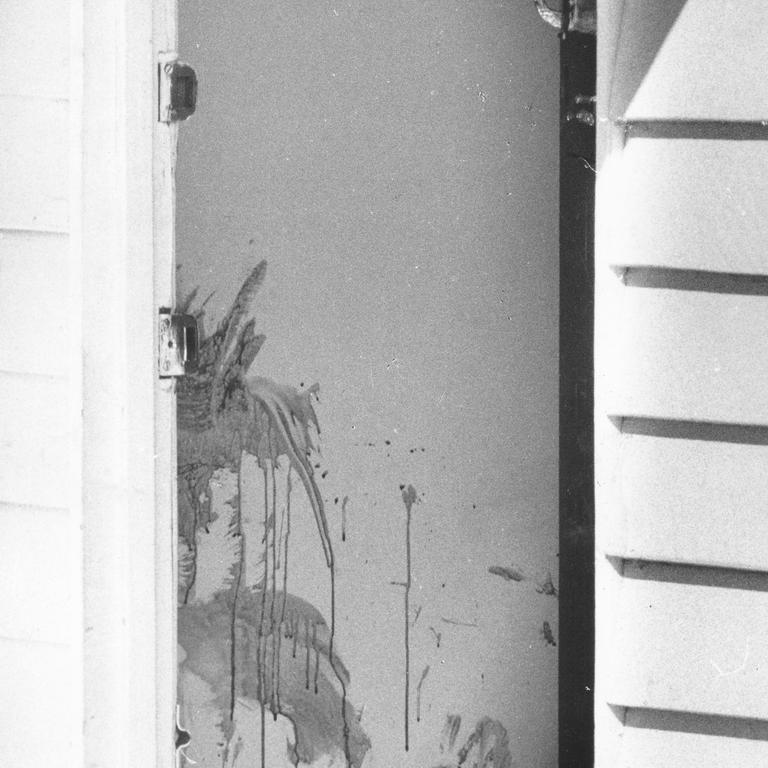 Christine Holznagel and her new boyfriend John Kingston were murdered at a Coorparoo home in 1979, with the 20-year-old's estranged husband John Holznagel later charged – Blood smeared wall just inside the front door of the house on Mona Street, Coorparoo where the body of a young women was found Picture Courier mail archive