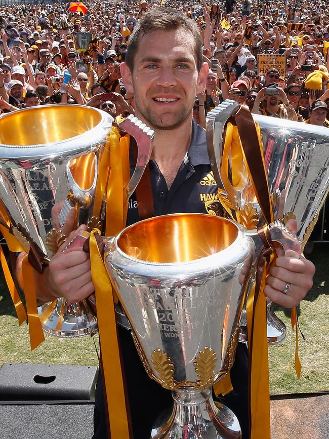 Hodge poses with the Hawks’ 2013, 2014 and 2015 premierships. Pic: Getty Images