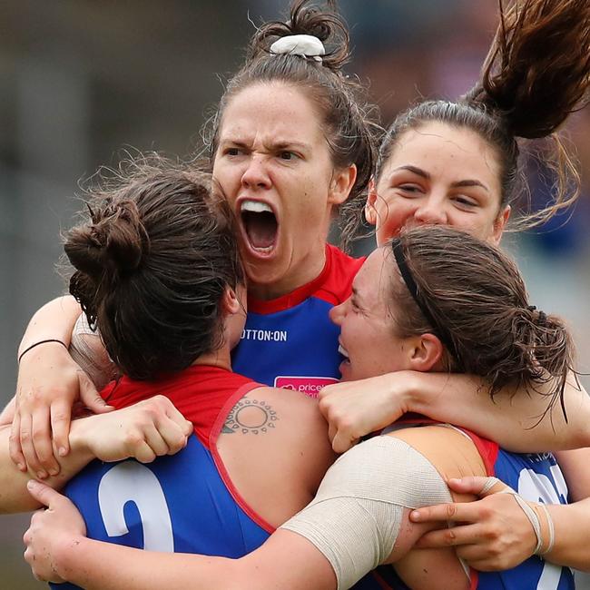 Emma Kearney (centre) celebrates after she kicked a goal with five minutes remaining in the 2018 grand final that kept the Bulldogs clear of the fast-finishing Lions. Picture: Adam Trafford / Getty Images