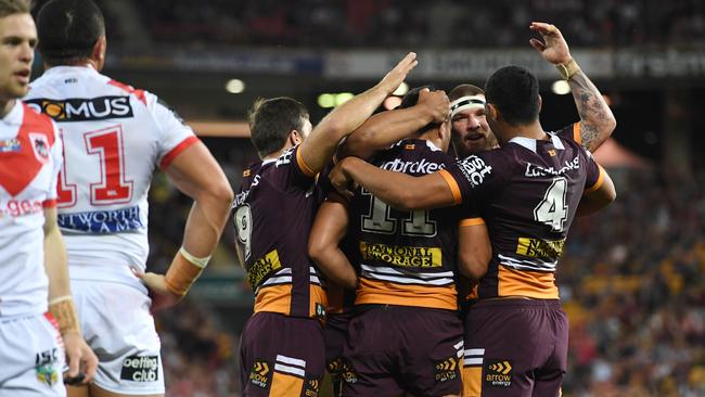 Brisbane Broncos players celebrate a try.