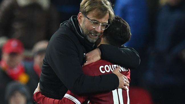 Liverpool's German manager Jurgen Klopp (L) hugs Liverpool's Brazilian midfielder Philippe Coutinho (R)